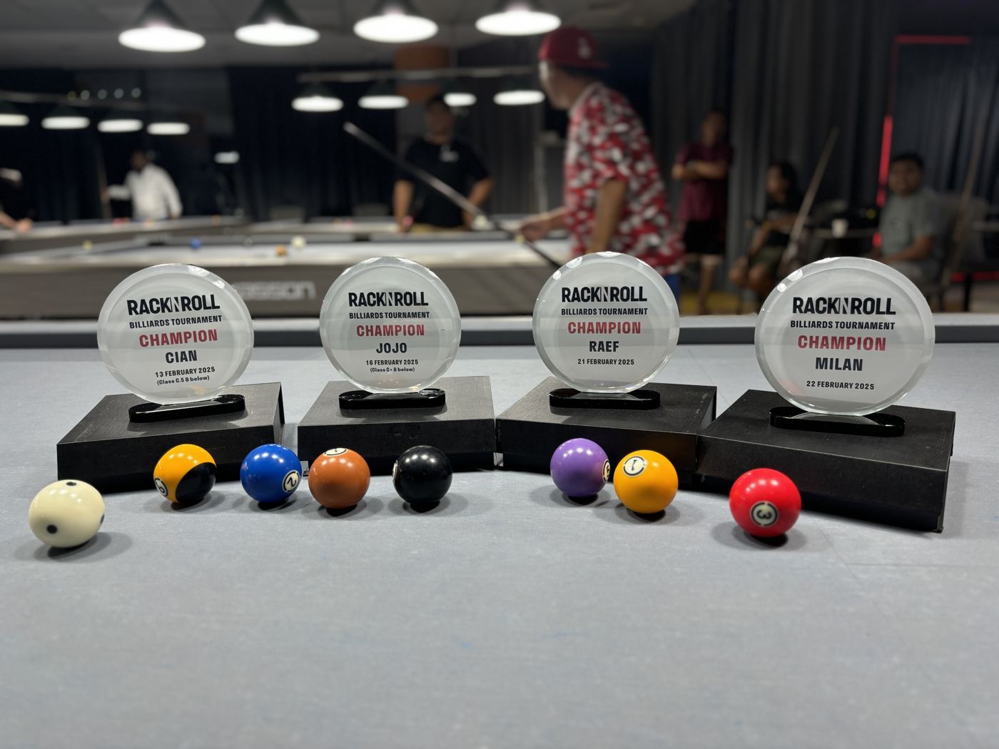 Tournament trophies and pool balls on a table